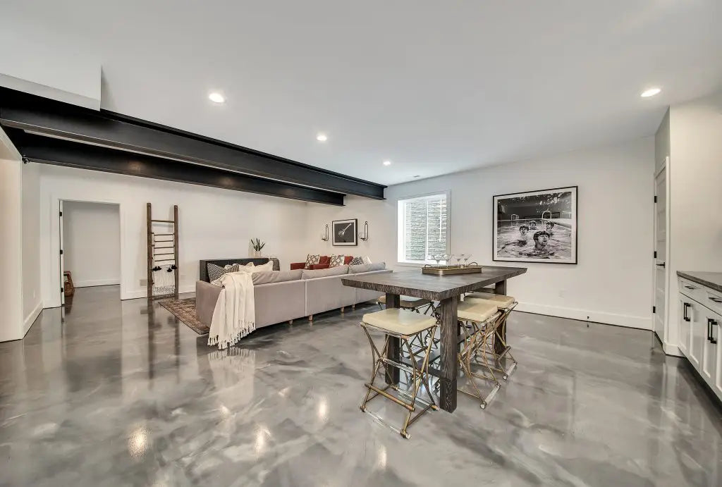 A beautifully finished residential basement featuring grey metallic epoxy flooring.